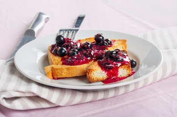 Delicious toasts bread with homemade currant jam with fork and knife