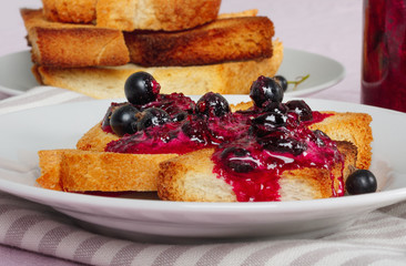 Delicious toasts bread with homemade currant jam  on bright  tablecloth