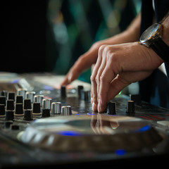 Closeup of DJ's hands mixing music