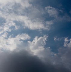 Naklejka na ściany i meble The white and gray cloudscape in the blue sky.