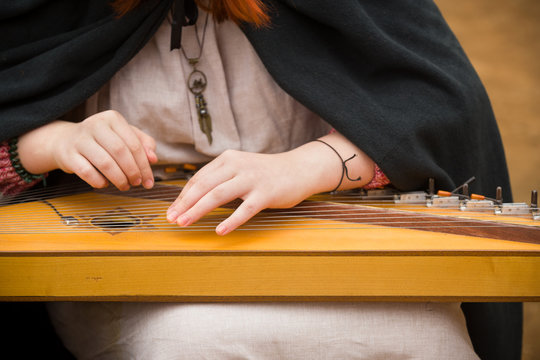 Closeup of woman's hands playing musical instrument - gusli.
