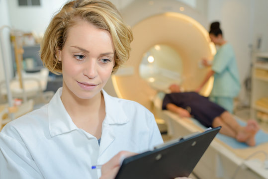 doctor writing the patients mri record