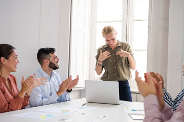 Woman being applauded at work after a presentation