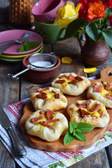 Mini pies made of puff pastry, custard and caramelized rhubarb. Homemade baking. Delicious freshly baked cookies. Rustic photo