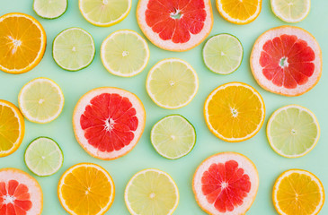 Citrus pattern on green background. Assorted citrus fruits. Slices of orange, tangerine, lemon, graperfruit,lime. Top view. Summer. Cocktail, juice, lemonade