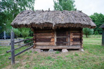 Barn with a thatched roof in a village in Poland