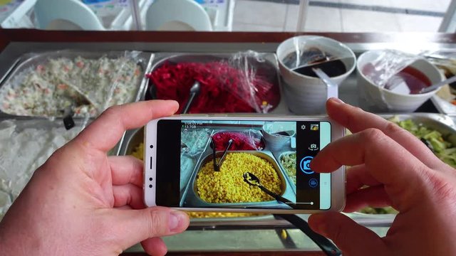 Taking photo of food with smartphone , mobile blogger. Social network concept.