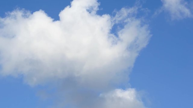 Ultra HD sunny cloudscape. Clouds move in blue sky. Timelapse clip of white fluffy clouds over blue sky, Beautiful white cloud soar across the screen in time lapse fashion, great good weather  
