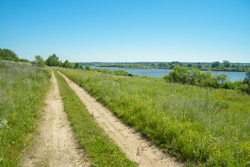a picturesque view, a road along the river