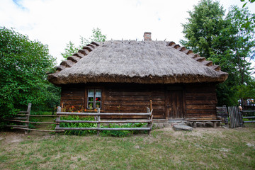 Wooden dos with a thatched roof in the village
