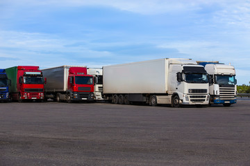 trucks in the Parking lot near the highway © Yuri Bizgaimer