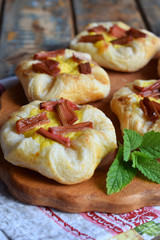 Mini pies made of puff pastry, custard and caramelized rhubarb. Homemade baking. Delicious freshly baked cookies. Rustic photo