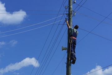 Electrician on a wooden pole