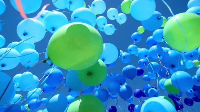 large-scale launch of helium balloons on a big holiday in the clear blue sky. entertainment industry, organization of mass events, festive mood