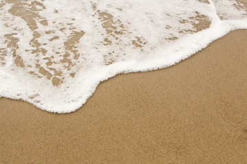 Fototapeta na wymiar Sea Foam Waves on the Beach
