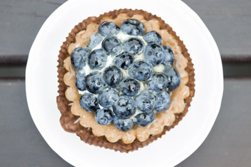 Sweet cake with blueberries on table close-up.