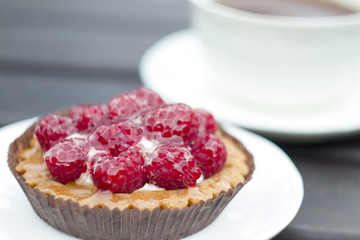 Sweet cake with raspberries on table close-up.