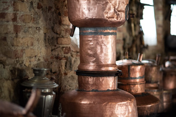Copper utensils: frying pans, hanging from the ceiling in the kitchen