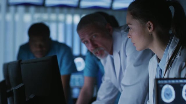 Diverse Group of Medical Scientists Solve Problems and Point at Computer Screens Showing CT, MRI Scans.
Shot on RED EPIC-W 8K Helium Cinema Camera.