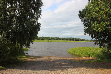 View from the shore to the slipway - sand slide for boats with trees at the edges