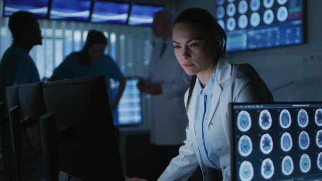 Female Scientist / Neurologist Working on a Personal Computer in Modern Laboratory. Medical Research Scientists Making New Discoveries. Shot on RED EPIC-W 8K Helium Cinema Camera.