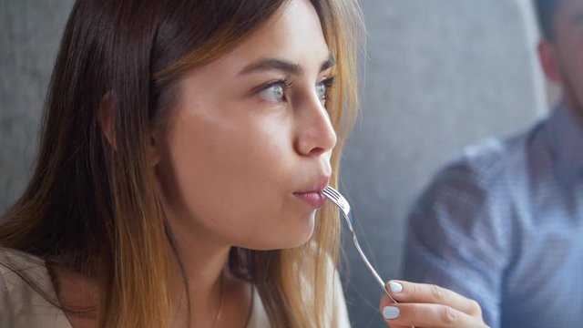 Girl eating cottage cheescakes during breakfast in the cafe