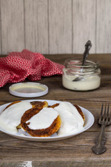 Pancakes with cottage cheese, sour cream in a white plate