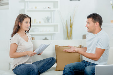 young couple arguing on the sofa