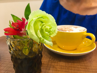 flowers and coffee on the background of a girl