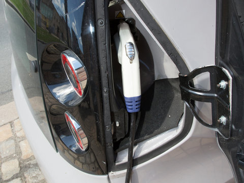 Charging modern electric car on the street is future of Automobile