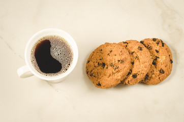 coffee cup and homemade cookies with chocolate/Breakfast whith coffee cup and homemade cookies with chocolate on a marble background. Top view