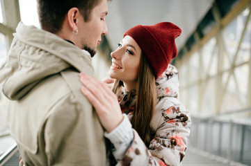 Lifestyle people. Young happy lovers embracing on meeting. Romantic pair of stylish cheerful hipsters hug. Girl in love. Happiness of loving youth couple. Emotional portrait of beautiful woman face.
