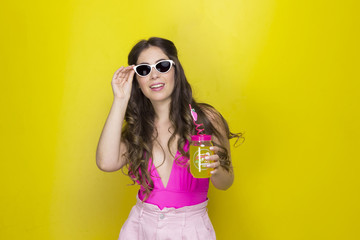  girl with long hair smiling with glasses drinking juice