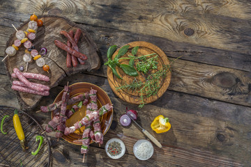 Fototapeta na wymiar bbq party fest Assortment various barbecue raw food meat, on plates wooden cutting board and grid on an old brown board background