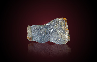 The mineral Galena on a red background