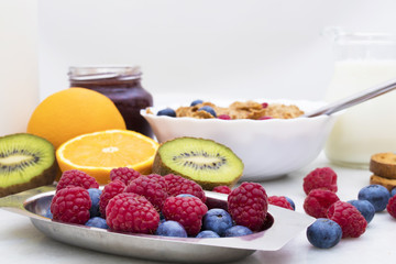 fresh fruit in the foreground with cereals and breakfast in the background, healthy food