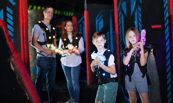 Brother and sister playing laser tag