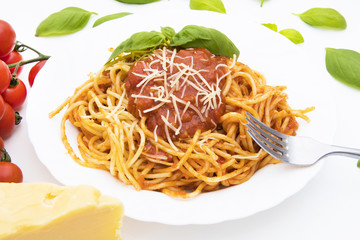 spaghetti dish with bolognese sauce and basil leaf