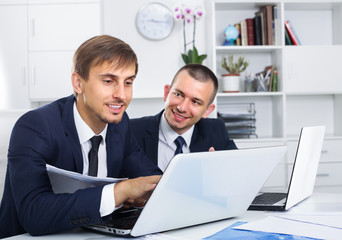 two young managers in office.