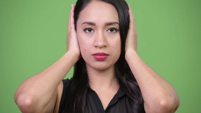 Young beautiful Asian businesswoman covering ears as three wise monkeys concept