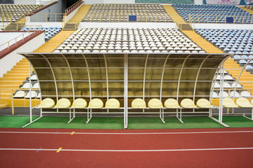 Obraz premium Empty bench football stadium spare sport concept near tribune and running road