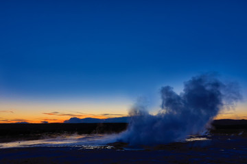 Clepsydra Geyser in the Lower geyser basin at Yellowstone National Park erupts almost continuously and looks spectacular at sunset at this park in Wyoming.