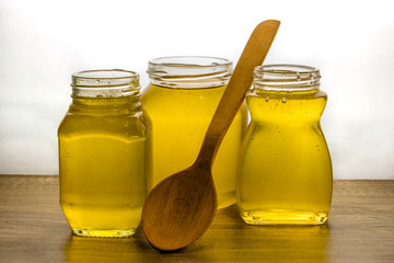 transparent liquid honey in glassware on a wooden table