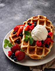 Belgium waffles with berries and ice cream