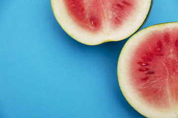 Fresh sliced watermelon on a bright blue background