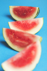 Fresh sliced watermelon on a bright blue background