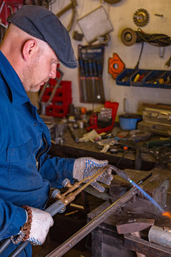 The young man, is going to cut a piece of metal autogenous welding.