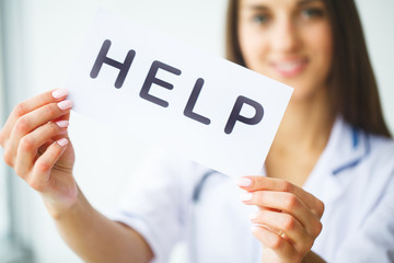 Health Care. Doctor Holding a Card With Symbol HELP, Medical Concept