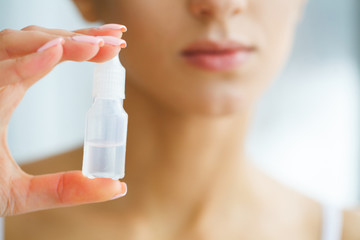 Vision And Medicine Concept. Young Girl Holds Eye Drops In Hands. Portrait of a Beautiful Woman with Contact Lenses. Healthy Look. High Resolution