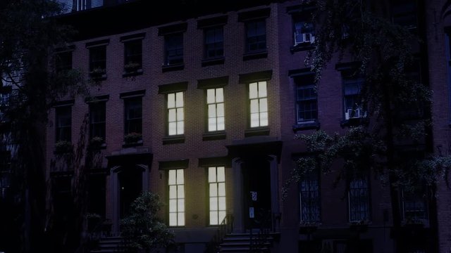 A Nighttime Exterior Establishing Shot Of A Typical Brooklyn Brownstone Residential Row House. Window Lights Turn On And Off. Simulated Day-for-night Treatment. Day/Night Matching Available.  	